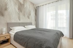 Кровать или кровати в номере Przytulny apartament Perła Bałtyku