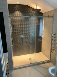 a shower with a glass door in a bathroom at Executive home in Mt Eden in Auckland