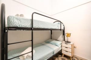 a bunk bed room with two bunk beds and a nightstand at Casa Vita 51 in Ceglie Messapica
