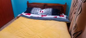 a bed with some pillows on top of it at Room in Kamakis Behind Greenspot opp 1 7 lounge in Ruiru