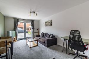 a living room with a couch and a table at 2 Bedroom Flat, Glasshoughton in Castleford