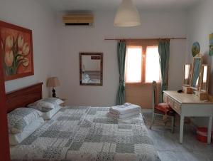 um quarto com uma cama, uma secretária e um lavatório. em Tara Casa Rural em Cartagena