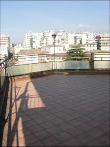 a shadow of a person on a balcony with a city at Attico in città con terrazza vista etna mare in Acireale