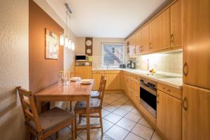 a kitchen with a wooden table and a dining room at Ferienwohnung Krempermoor 1 in Krempermoor