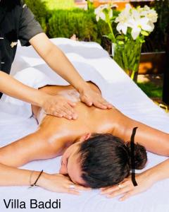 a woman getting a massage on a bed at Villa Baddi Marrakech in Marrakesh