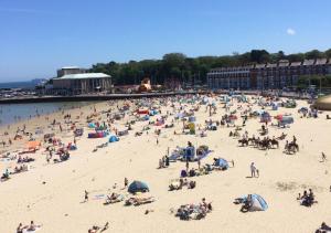 um grande grupo de pessoas numa praia em Sea Breeze Weymouth em Weymouth