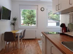 a kitchen with a table and a table and chairs at Happy Vibes apartment, charming & with free parking in Ljubljana