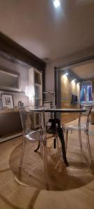 a glass table and two chairs in a room at Gondola Azzurra in Civitanova Marche