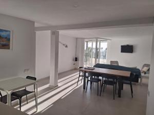 a living room with a dining room table and chairs at Apartamento en primera línea de mar de Salou in Salou