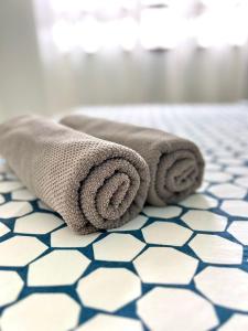 a pair of towels sitting on a bathroom floor at SEAVIEW HOLIDAY APARTMENT 6-Free WiFi & Netflix in Kuala Terengganu