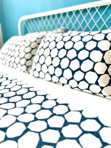 a bed with a white hexagonal pattern on it at SEAVIEW HOLIDAY APARTMENT 6-Free WiFi & Netflix in Kuala Terengganu