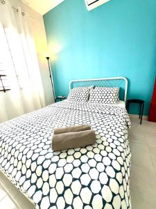 a bedroom with a bed with a blue wall at SEAVIEW HOLIDAY APARTMENT 6-Free WiFi & Netflix in Kuala Terengganu