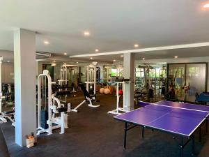 a gym with a ping pong table and machines at PANIDA@AVANTA in Koh Samui 