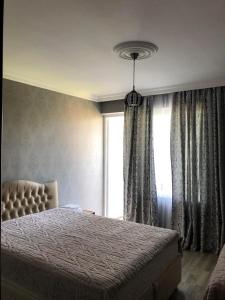 a bedroom with a bed and a window at Cottage Gio in Kobuleti