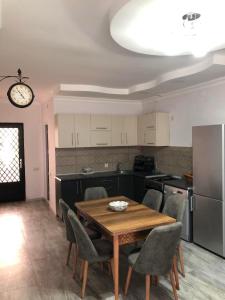a kitchen with a table and chairs and a refrigerator at Cottage Gio in Kobuleti