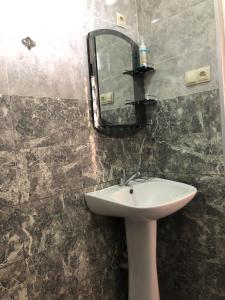 a bathroom with a sink and a mirror on the wall at Cottage Gio in Kobuleti