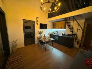 a kitchen and dining room with a table and chairs at Hoszów 28D in Hoszów