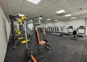 a gym with lots of equipment in a room at Sea view Penthouse ABELIA 12 floors iskele Cyprus in Iskele