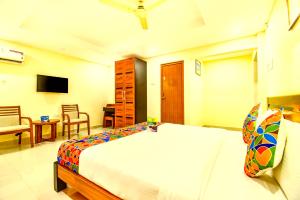 a bedroom with a large bed and a living room at K HOTELS - CHENNAI AIRPORT in Chennai