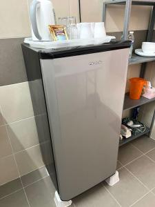 a small refrigerator in a kitchen next to a shelf at SEAVIEW HOLIDAY APARTMENT 6-Free WiFi & Netflix in Kuala Terengganu