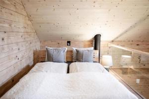 a bedroom with two beds in a wooden cabin at Unterkunft SPYCHER WEGGIS in Weggis