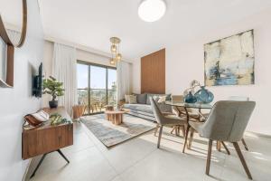 ein Wohnzimmer mit einem Tisch und einem Sofa in der Unterkunft Luxurious 1BDR Terrace Parking in City Central in Jerusalem
