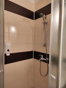 a bathroom with a shower with black and white stripes at Nev in Burgas City