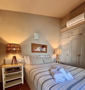 a bedroom with a bed with two towels on it at GM House Minorca in Cala en Bosc