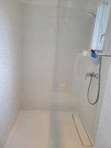 a white shower with a hose in a bathroom at A VIGNA VECCHIA chambre d'hôtes in Porto-Vecchio +23 photos