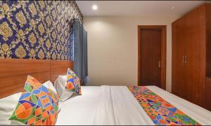 a bedroom with a large bed with a wooden headboard at FabHotel The Wind Palace in Jaipur