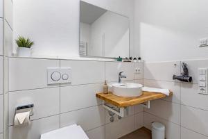 un baño con lavabo y espejo en Km Style Apartments 7, en Freiburg im Breisgau 16 fotos más