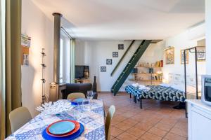 a dining room with a table and a living room at Casa Ginevra - 3 Minutes Walk from the Sea in Livorno