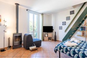 a living room with a bed and a staircase at Casa Ginevra - 3 Minutes Walk from the Sea in Livorno
