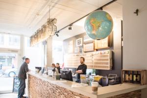 a restaurant with people standing at a counter at Wombat's City Hostel Munich Hauptbahnhof in Munich