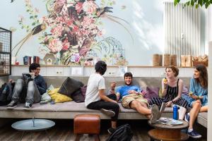 a group of people sitting on a couch at Wombat's City Hostel Munich Hauptbahnhof in Munich