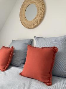 a mirror on the wall above a bed with pillows at Chez David et Bene in Rennes