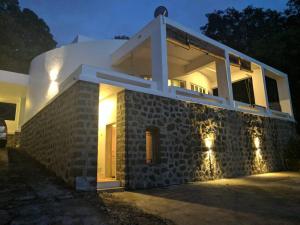 a house with lights on the side of it at Ashine villa in Alībāg