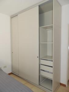 a white closet with glass doors in a room at Temporario en Resistencia con cochera in Resistencia