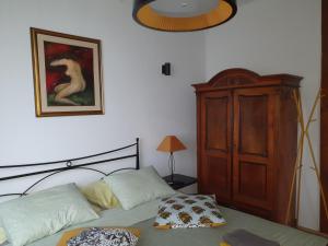 a bedroom with a bed and a wooden cabinet at Apartment with Terrace Nona Pavla in Tolmin
