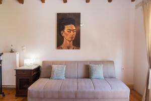 a couch in a living room with a painting on the wall at Grand Skylight in Corfu Town