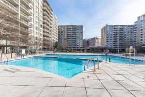 a swimming pool in a city with tall buildings at Urban Charm: 2BR Modern Retreat Close to Downtown in Arlington