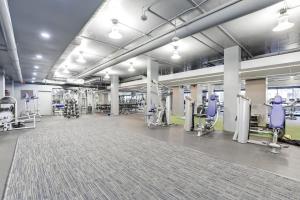 a gym with exercise equipment in a large room at Urban Charm: 2BR Modern Retreat Close to Downtown in Arlington
