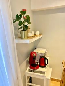 a small kitchen with red appliances on a shelf at Chambre Chants d'oiseaux in Brussels