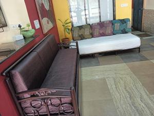 a living room with a couch and a bench at Sequence Villa in Mumbai