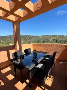 a table and chairs on a patio with a view at Ruim Penthouse Elviria Marbella met groot terras in Marbella