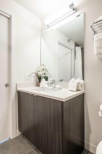 a bathroom with a sink and a mirror at 3BR Luxury Glass Apartment With Views Pool & Gym in Chicago