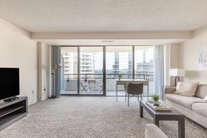 a living room with a couch and a table at 2BR Executive Apartment with Balcony in Arlington