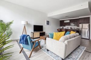 a living room with a couch and a kitchen at 2BR Premium Downtown Suite in Detroit