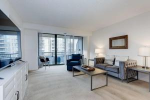 a living room with a couch and a table at 2BR Central Apartment Spacious Layout & Balcony in Arlington