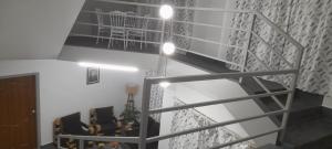 a room with a staircase with chairs and a table at Medajied Guest House in Shillong +8 photos